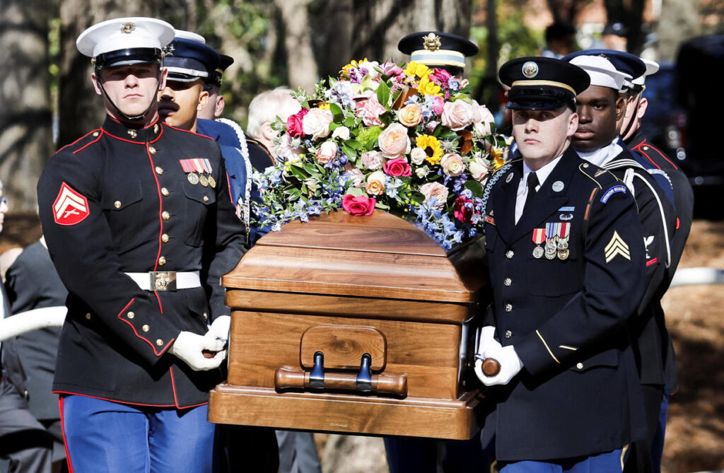 A military honor guard carries the casket of former first lady Rosalynn Carter from the Jimmy Carter Presidential Library and Museum en route to a memorial service at Emory University's Glenn Memorial Church, in Atlanta, Georgia, Nov. 28, 2023.