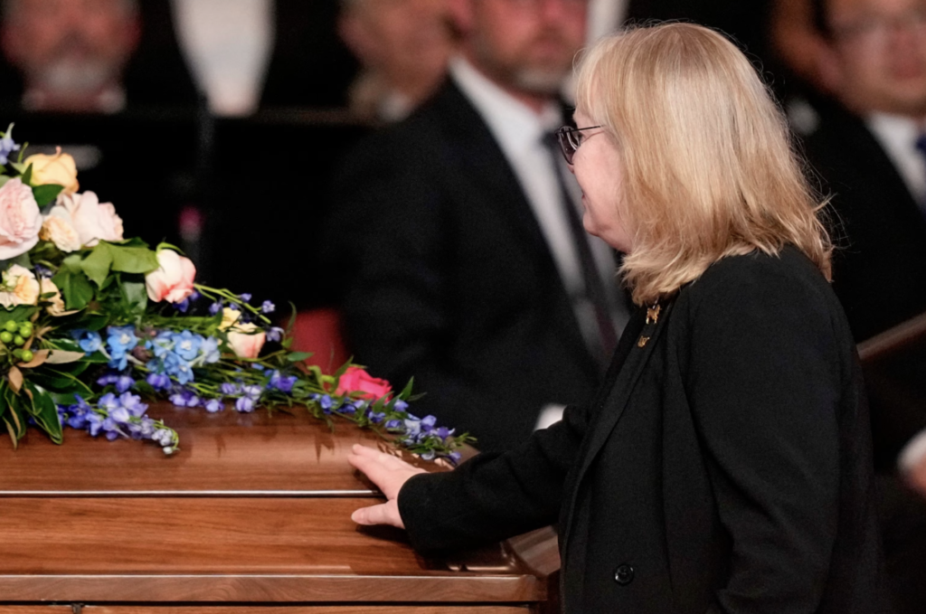 Amy Carter, daughter of former US President Jimmy Carter, touches the casket after speaking during a tribute service for former US First Lady Rosalynn Carter, at Glenn Memorial Church in Atlanta, on Nov. 28, 2023.Brynn Anderson/POOL/AFP via Getty Images 