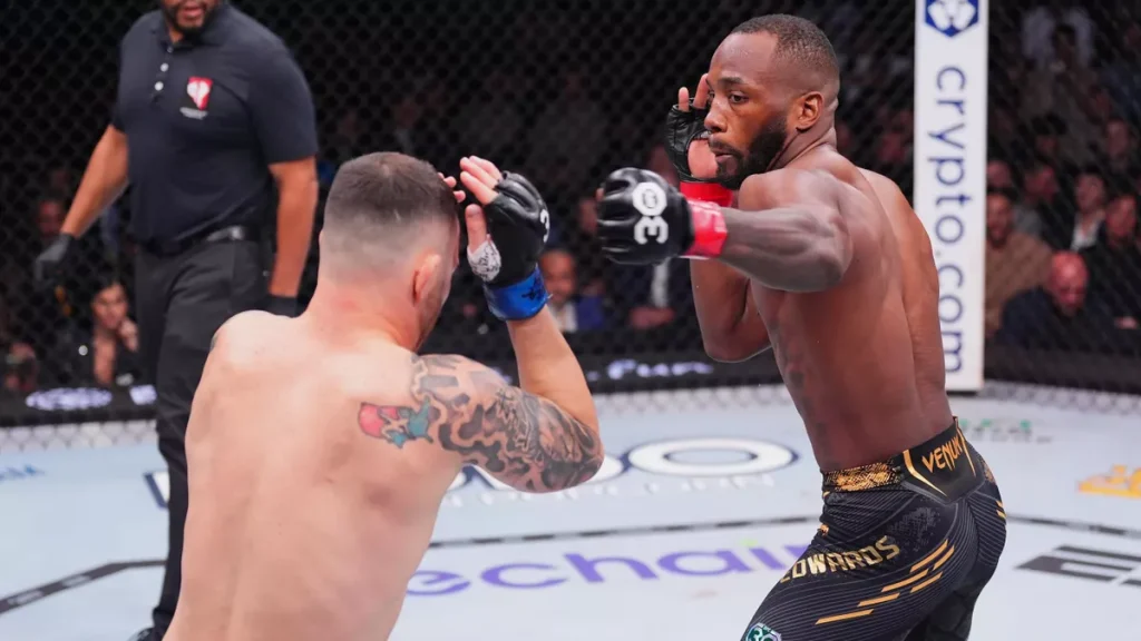 LAS VEGAS, NEVADA - DECEMBER 16: (L-R) Leon Edwards of Jamaica kicks Colby Covington in the UFC welterweight championship fight during the UFC 296 event at T-Mobile Arena on December 16, 2023 in Las Vegas, Nevada. (Photo by Jeff Bottari/Zuffa LLC via Getty Images)