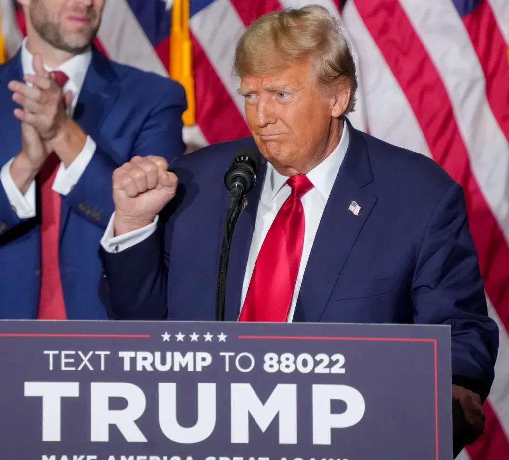 Former President Donald Trump pumps his fist Monday, Jan. 15, 2024, at the Trump caucus night watch party at the Iowa Events Center in Des Moines.