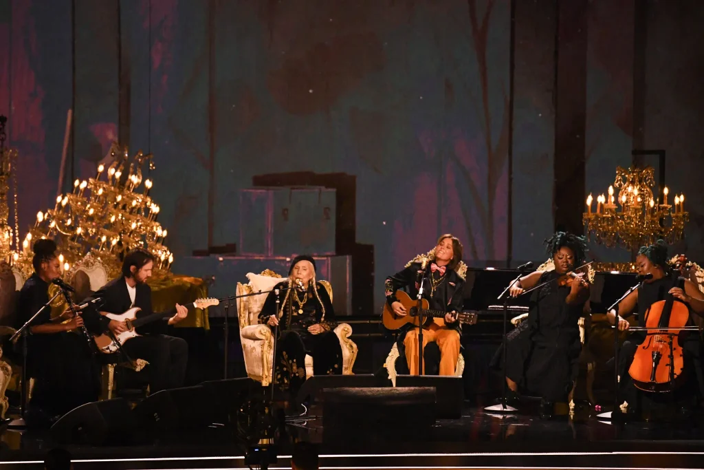 Joni Mitchell won a Grammy for best folk album, then performed with a group of musicians.Credit...Valerie Macon/Agence France-Presse